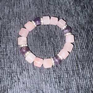 Pink rose quartz beads and purple amethyst stones with silver accent spacers.